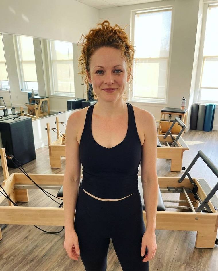Hannah, a Pilates instructor, in the studio after an early class